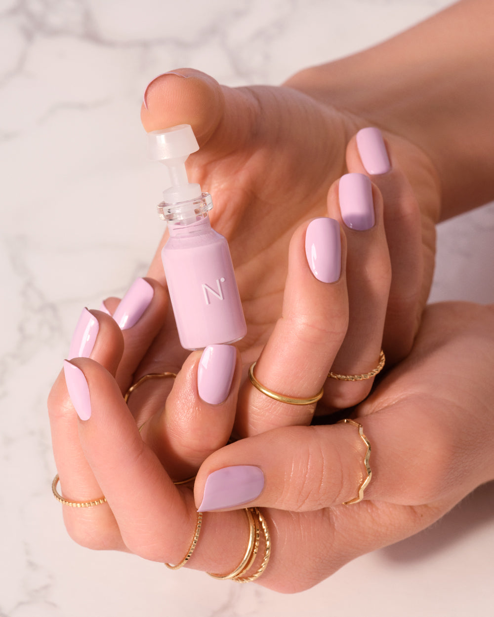 hands holding nimble nail polish capsule