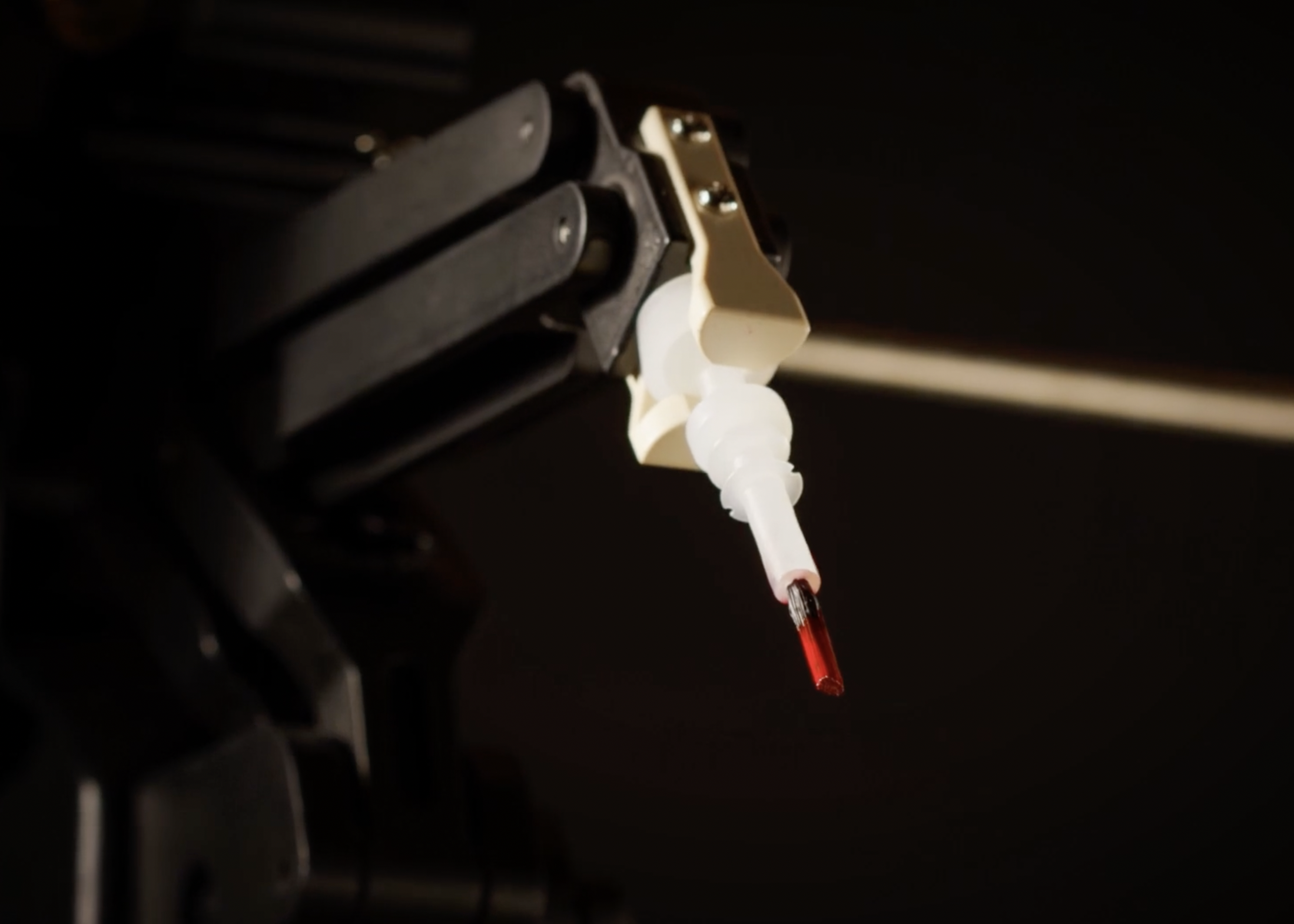 nimble robot arm holding capsule brush